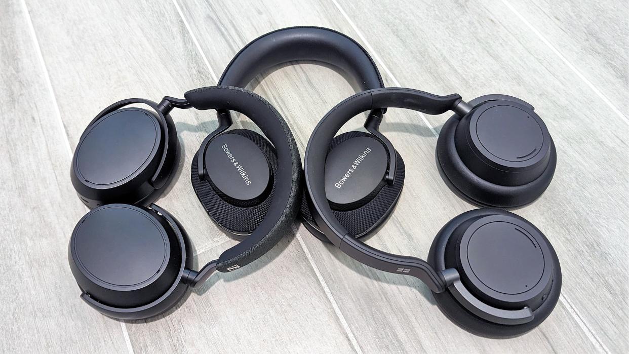  Collection of three over-ear headphones arranged on a floor  