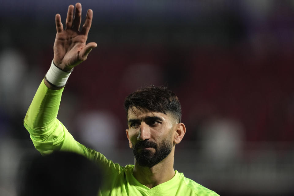 Iran's goalkeeper Ali Reza Safarbeiranvand waves to the fans after his team's victory during the Asian Cup round of 16 soccer match between Syria and Iran at Abdullah Bin Khalifa Stadium in Doha, Qatar, Wednesday, Jan. 31, 2024. (AP Photo/Thanassis Stavrakis)