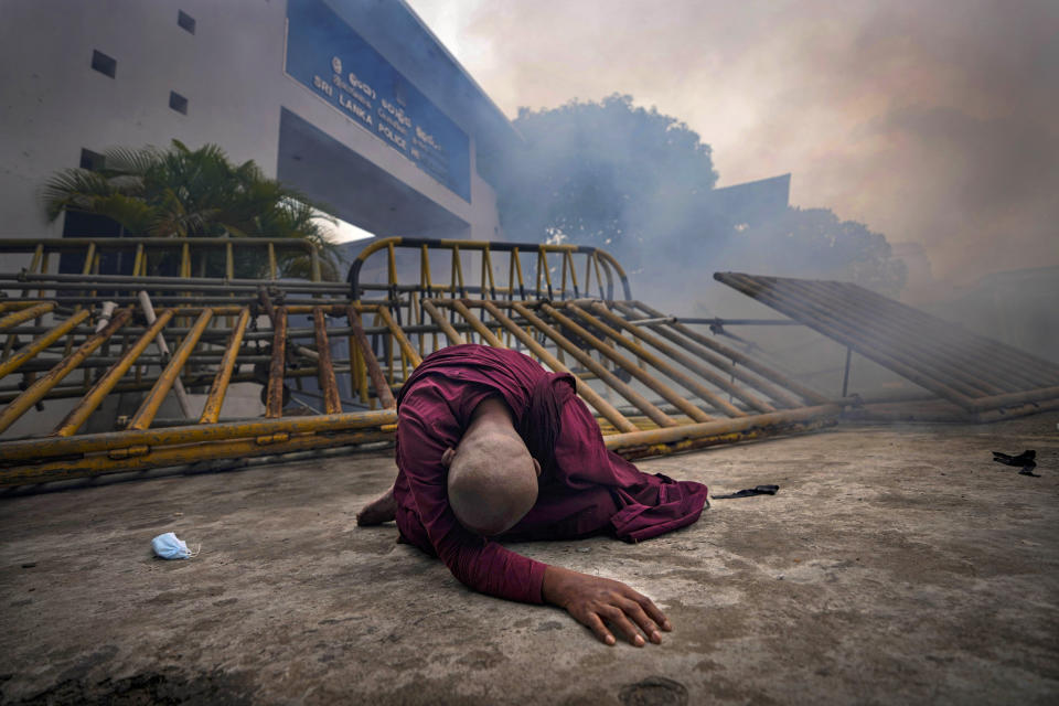 FILE- A Buddhist nun falls next to a barricade after inhaling tear gas during a protest against the economic crisis outside police headquarters in Colombo, Sri Lanka, June 9, 2022. Prime Minister Ranil Wickremesinghe told Parliament on Wednesday that Sri Lanka’s economy has collapsed after months of shortages of food, fuel and electricity. (AP Photo/Eranga Jayawardena, File)