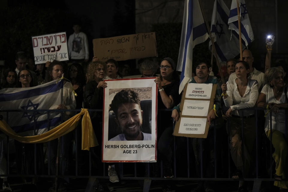 Israelis hold signs and photos of those who were kidnapped by Hamas militants during a protest calling for their return, in Jerusalem, Sunday, Oct. 22, 2023. On Oct. 7, the militant Hamas rulers of the Gaza strip carried out an unprecedented, multi-front attack that killed over 1,400 and captured more than 200. (AP Photo/Mahmoud Illean)