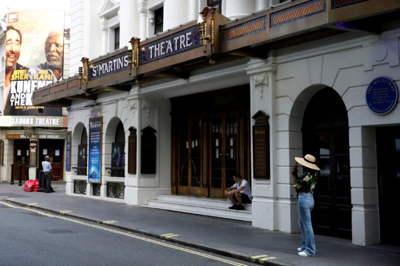 FILE PHOTO: FILE PHOTO: People stand next to St Martin's Theatre at London's West End in London