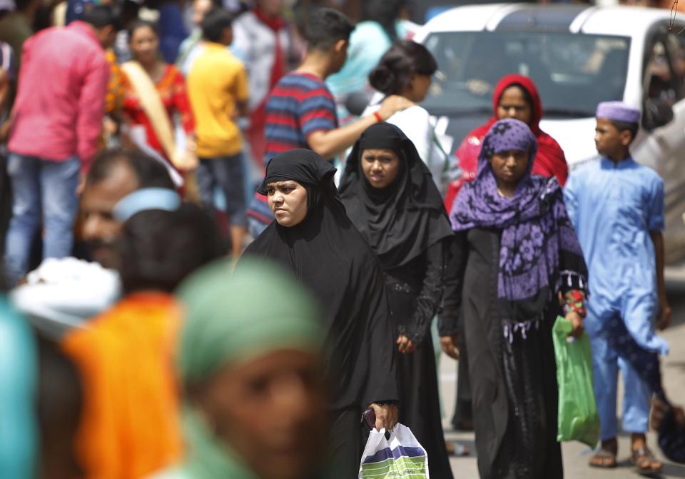 People throng a market on the eve of Eid al Adha, in Jammu, India, Sunday, Aug.11, 2019. Authorities in Indian-administered Kashmir said that they eased restrictions Sunday in most parts of Srinagar, the main city, ahead of an Islamic festival following India's decision to strip the region of its constitutional autonomy. There was no immediate independent confirmation of reports by authorities that people were visiting shopping areas for festival purchases as all communications and the internet remain cut off for a seventh day. (AP Photo/Channi Anand)