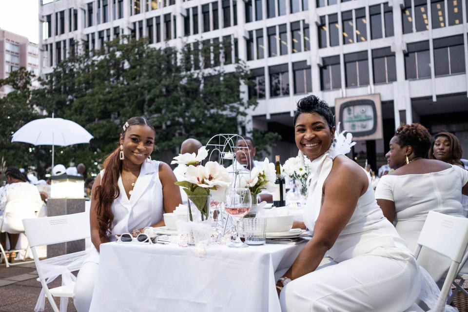 Ericka Vaughn, left, and Kim Bennett, right, enjoy Diner en Blanc in Court Square on Aug. 31, 2019.