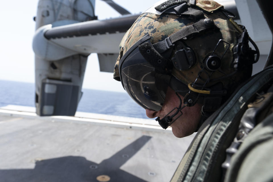 U.S. Marie Corps Cpl. Jacob Simons watches as his VM-22 Osprey lands on the USS Arlington for refueling Saturday, Aug. 28, 2021, in the Caribbean Sea near Haiti. The VMM-266, "Fighting Griffins," from Marine Corps Air Station New River, from Jacksonville, N.C., are flying in support of Joint Task Force Haiti after a 7.2 magnitude earthquake on Aug. 22, caused heavy damage to the country. (AP Photo/Alex Brandon)