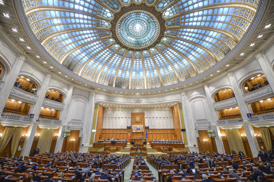 Romanian Prime Minister designate Nicolae Ciuca delivers a speech before a parliament vote on his government team in Bucharest, Romania, Thursday, Nov. 25, 2021. Romanian lawmakers voted in favor of a new coalition government led by a Liberal former army general, which could usher in an end to a months-long political crisis in the Eastern European nation.(AP Photo/Alexandru Dobre)