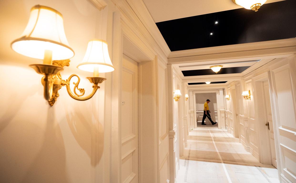 A worker walks by a replica of the First Class hallway that is part of "Titanic: The Artifact Exhibition" at COSI.