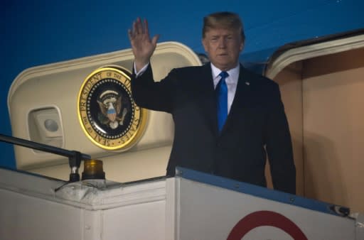 Trump waves after Air Force One arrived at Paya Lebar Air Base in Singapore