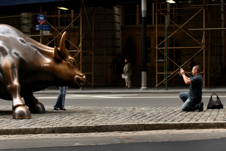 A tourist takes a picture of the Wall St. bull on September 30, 2008 in New York City. (Photo by Spencer Platt/Getty Images)