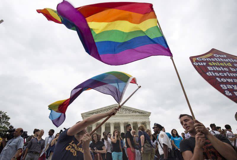 FILE PHOTO: Supporters of gay marriage wave the rainbow flag after the U.S. Supreme Court ruled on Friday that the U.S. Constitution provides same-sex couples the right to marry