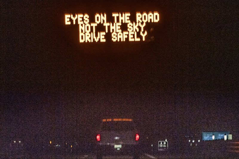 A sign over Interstate 80 warns drivers to use caution prior to an annular eclipse in Winnemucca, Nev., in October. Millions of travelers are expected to descend on various parts of the United States to watch the April 8 solar eclipse. File Photo by Terry Schmitt/UPI