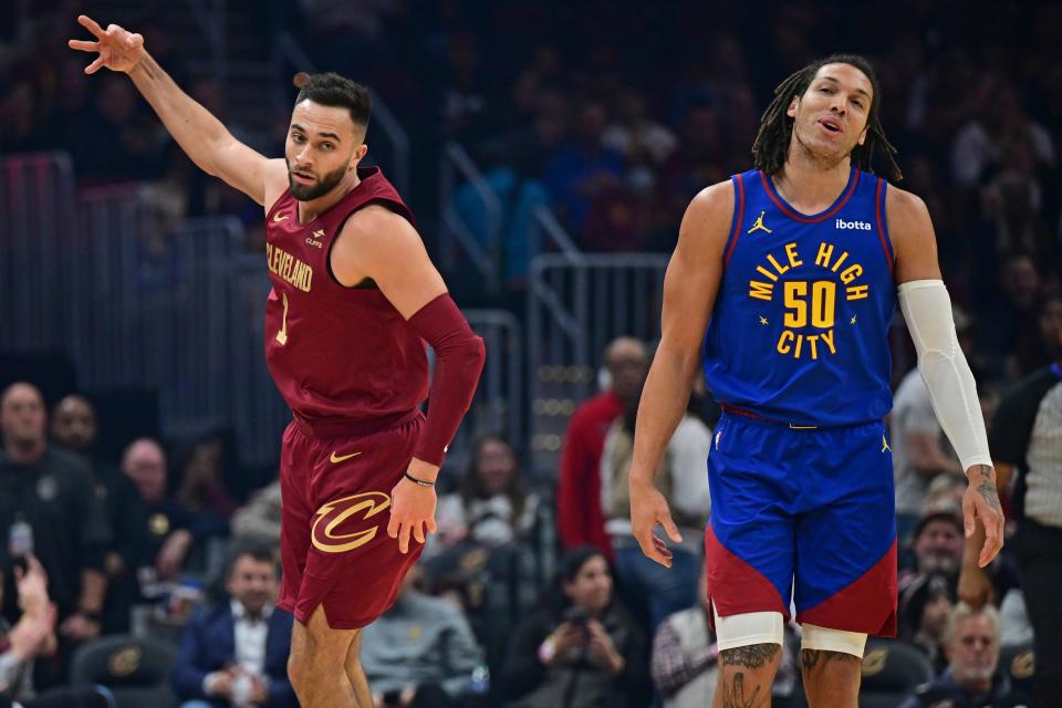Cavaliers guard Max Strus celebrates after a 3-pointer over Denver Nuggets forward Aaron Gordon in the first half, Sunday, Nov. 19, 2023, in Cleveland.