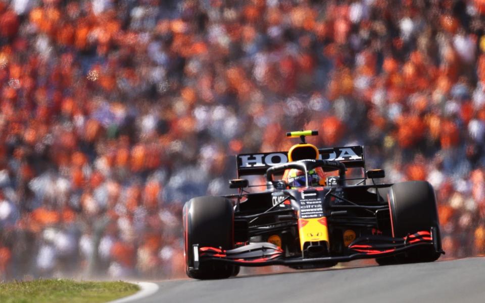 Sergio Perez of Mexico driving the (11) Red Bull Racing RB16B Honda on their way to the grid prior to the F1 Grand Prix of The Netherlands at Circuit Zandvoort on September 05, 2021 in Zandvoort, Netherland - Lars Baron/Getty Images