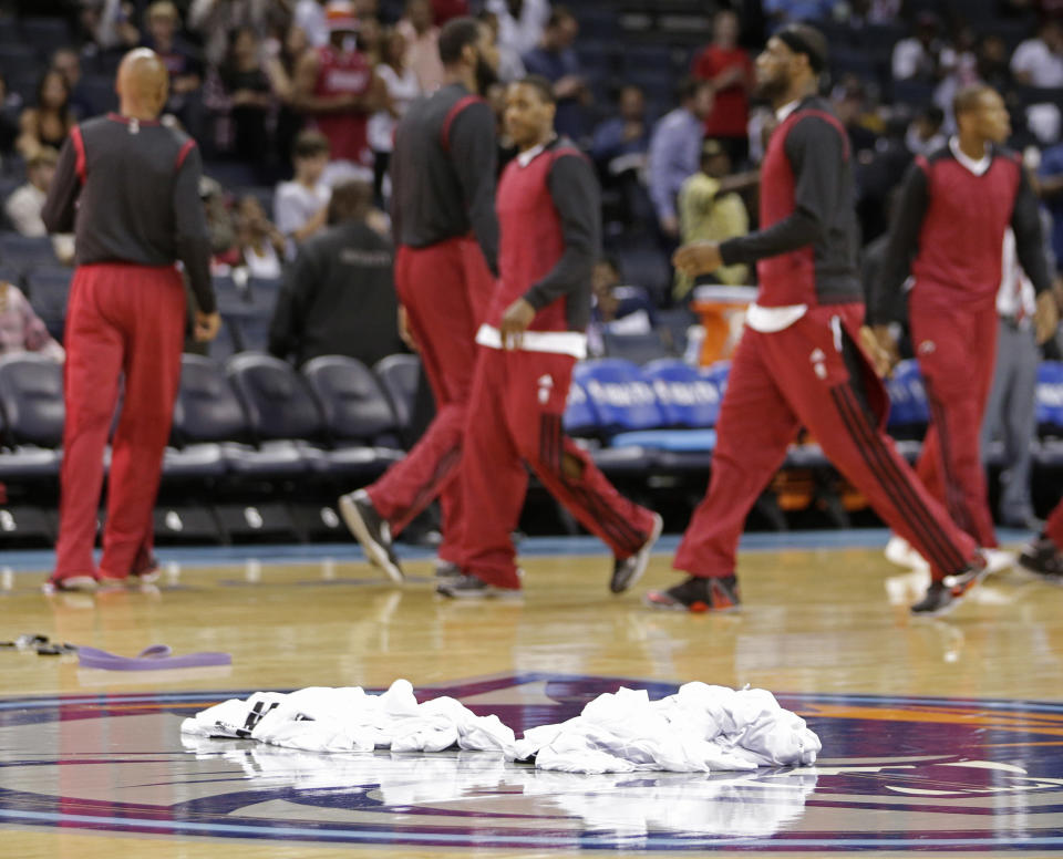 Warm-up shirts are piled at center court as Miami Heat players prepare for Game 4 of an opening-round NBA basketball playoff series against the Charlotte Bobcats in Charlotte, N.C., Monday, April 28, 2014. (AP Photo/Chuck Burton)