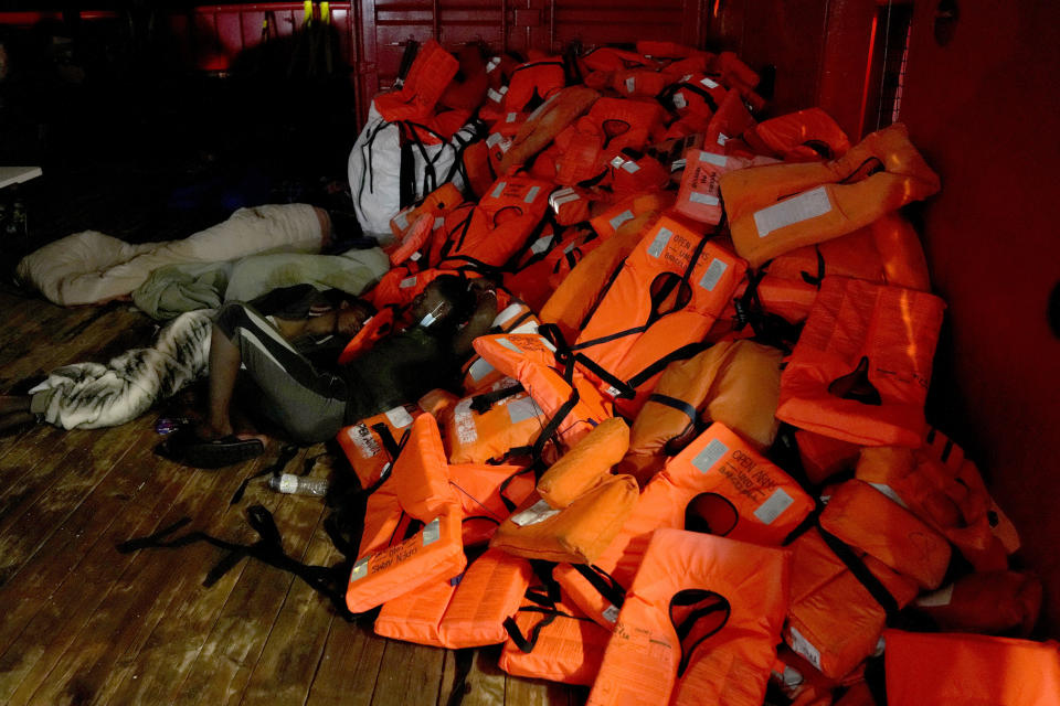 Migrants sits by the life jackets on the deck after they were rescued from Spanish NGO Open Arms lifeguard at the Mediterranean sea, early Sunday, Sept. 18, 2022. Around 200 migrants from Syria and Africa countries were rescued by NGO Open Arms crew members. (AP Photo/Petros Karadjias)