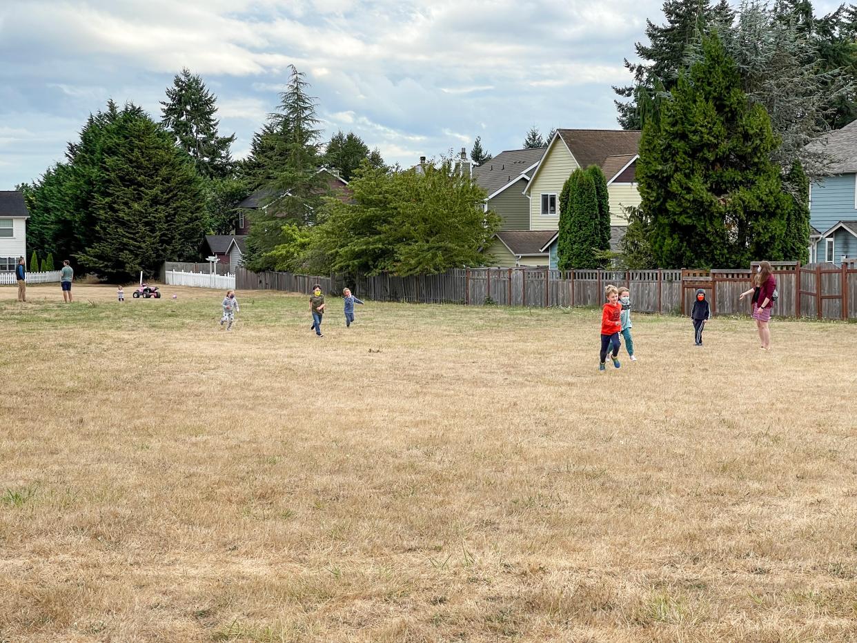 Kids play on the old parade grounds in the Fort Ward neighorhood.