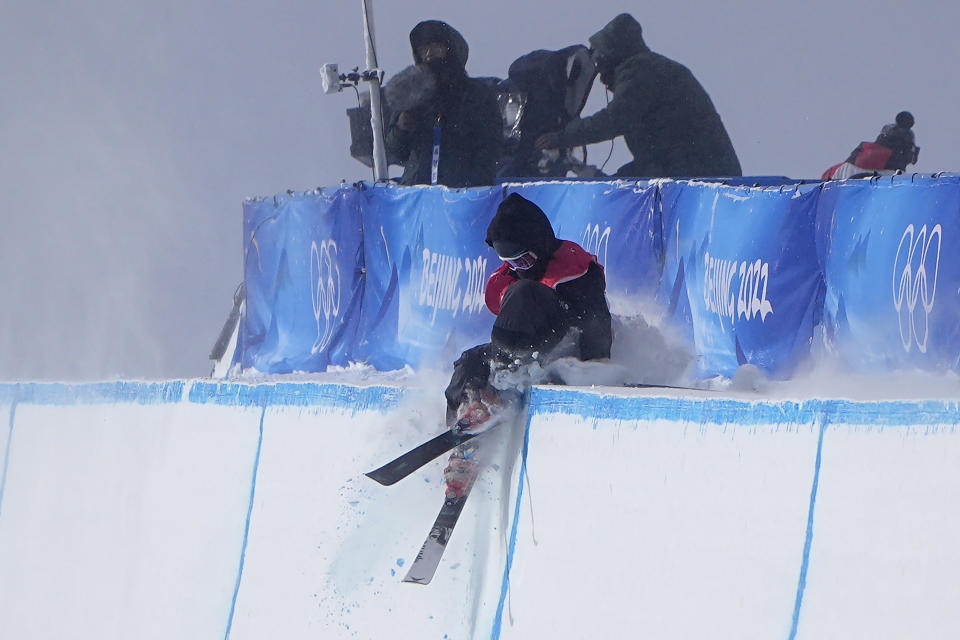 Britain's Gus Kenworthy crashes during the men's halfpipe finals at the 2022 Winter Olympics, Saturday, Feb. 19, 2022, in Zhangjiakou, China. (AP Photo/Gregory Bull)