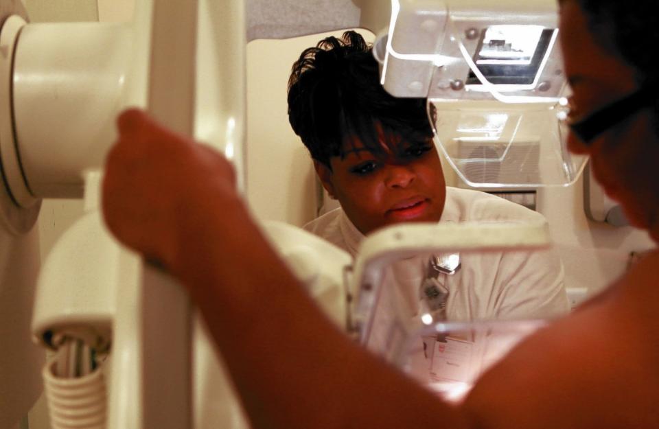 A woman receives a mammogram