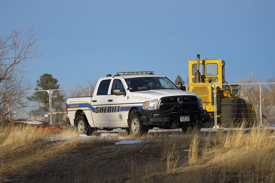 A Boulder County Sheriff's officer keeps watch near the suspected origin of the Marshall wildfire Monday, Jan. 3, 2022, in Boulder, Colo. (AP Photo/Jack Dempsey)