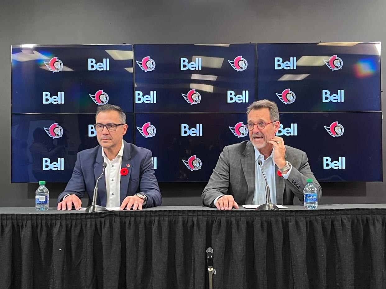 Steve Staios (left) and Michael Andlauer (right) are seen at an Ottawa Senators press conference in November when Staios was named the club's interim general manager. The team confirmed Sunday that the role had been made permanent. (Avanthika Anand/CBC - image credit)