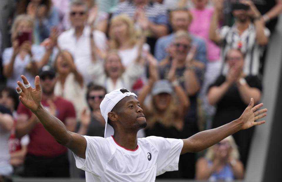 Christopher Eubanks of the US celebrates after beating Stefanos Tsitsipas of Greece in a men's singles match on day eight of the Wimbledon tennis championships in London, Monday, July 10, 2023. (AP Photo/Alastair Grant)