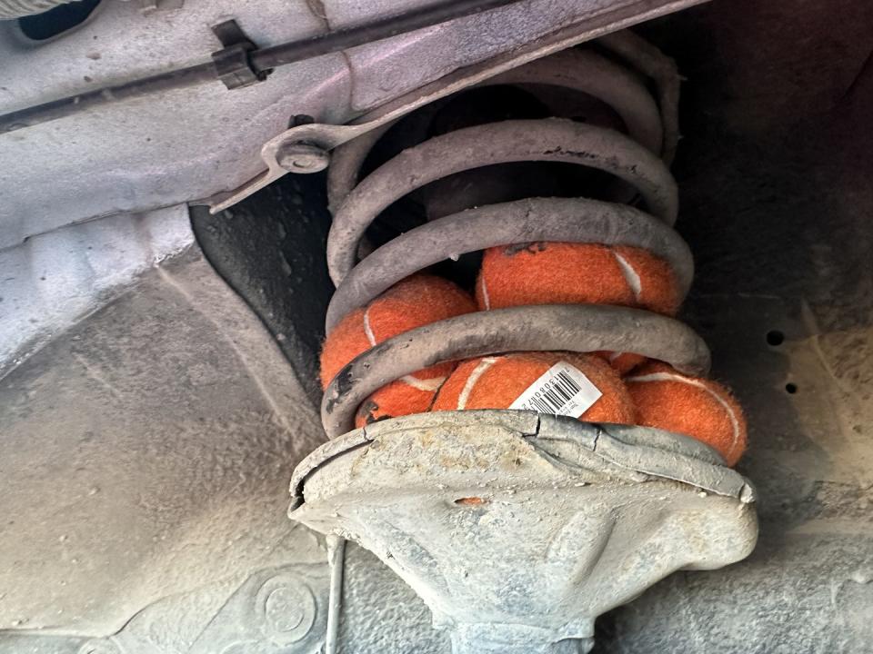 tennis balls stuffed in a coil spring