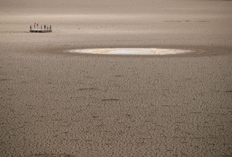 FILE PHOTO: Children play as caked clay is seen in the dried up municipal dam in drought-stricken Graaff-Reinet