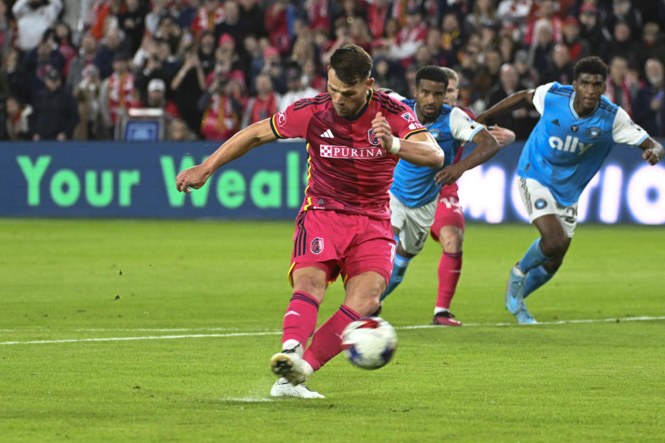 St. Louis City SC midfielder Eduard Lowen, foreground, kicks a penalty goal against Charlotte FC during the first half of an MLS soccer match Saturday, March 4, 2023, in St. Louis. (AP Photo/Joe Puetz)