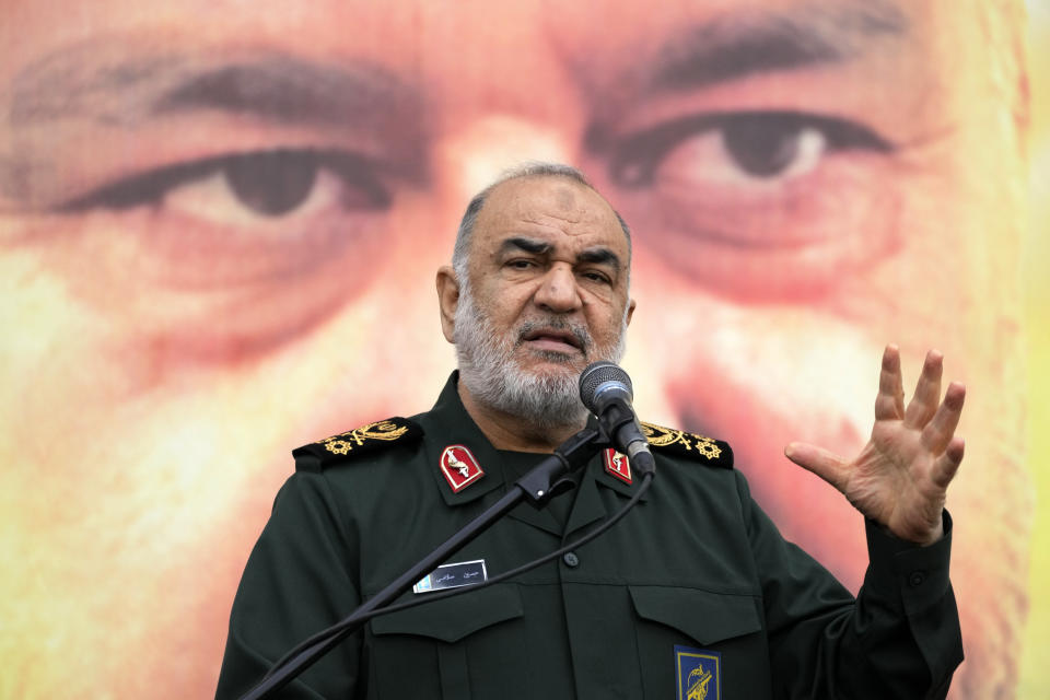 Chief of Iran's paramilitary Revolutionary Guard Gen. Hossein Salami addresses in front of the portrait of Seyed Razi Mousavi, a high ranking general of the guard, who was killed in an alleged Israeli airstrike in Syria on Monday, during his funeral ceremony in Tehran, Iran, Thursday, Dec. 28, 2023. (AP Photo/Vahid Salemi)