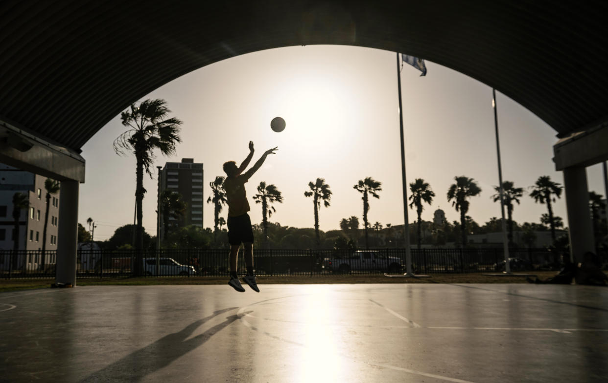 A resident plays basketball during a heat wave in Corpus Christi, Texas on July 20, 2023.   (Eddie Seal / Bloomberg via Getty Images)