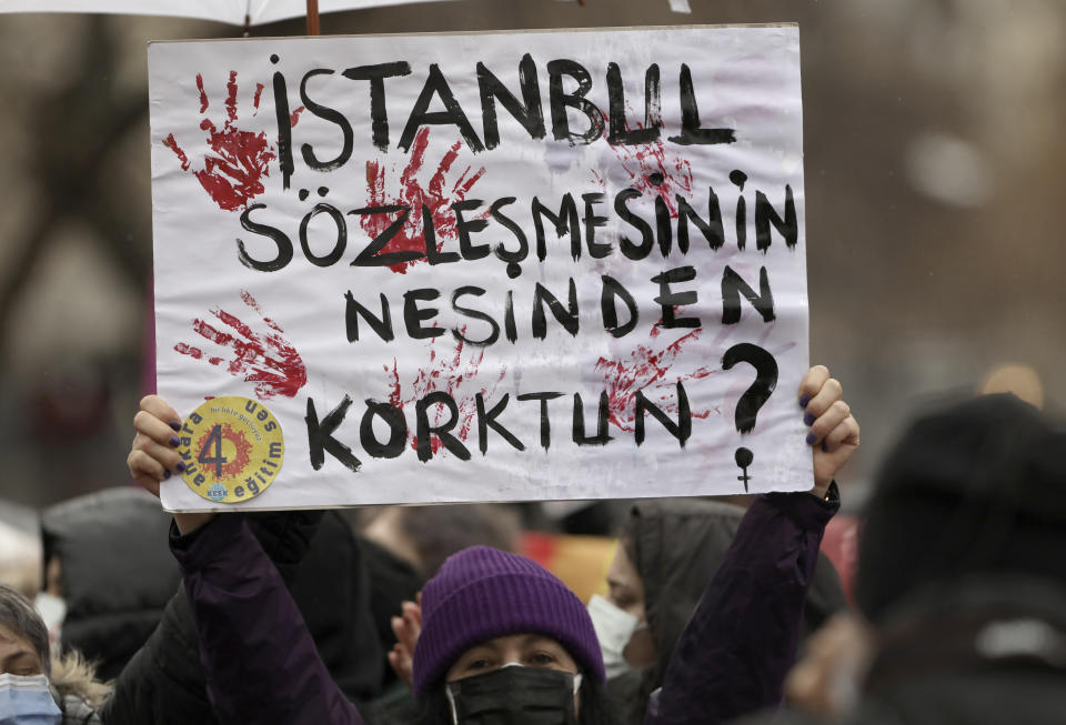 A woman holds a placard that reads: "Why do you fear the Istanbul Convention?" during a protest rally in Ankara, Turkey, Saturday, March 20, 2021. Turkey has withdrawn from a European treaty protecting women from violence that it was the first country to sign a decade ago and that bears the name of its largest city. President Recep Tayyip Erdogan’s decree early Saturday annulling Turkey’s ratification of the Istanbul Convention is a blow to women’s rights advocates who say the agreement is crucial to combat domestic violence. (AP Photo/Burhan Ozbilici)