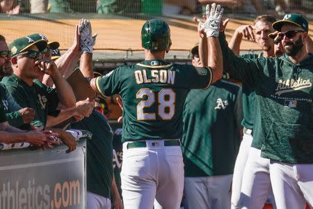 Sep 8, 2018; Oakland, CA, USA; Oakland Athletics first baseman Matt Olson (28) celebrates with teammates after hitting a solo home run against the Texas Rangers during the eighth inning at the Oakland Coliseum. Mandatory Credit: Stan Szeto-USA TODAY Sports