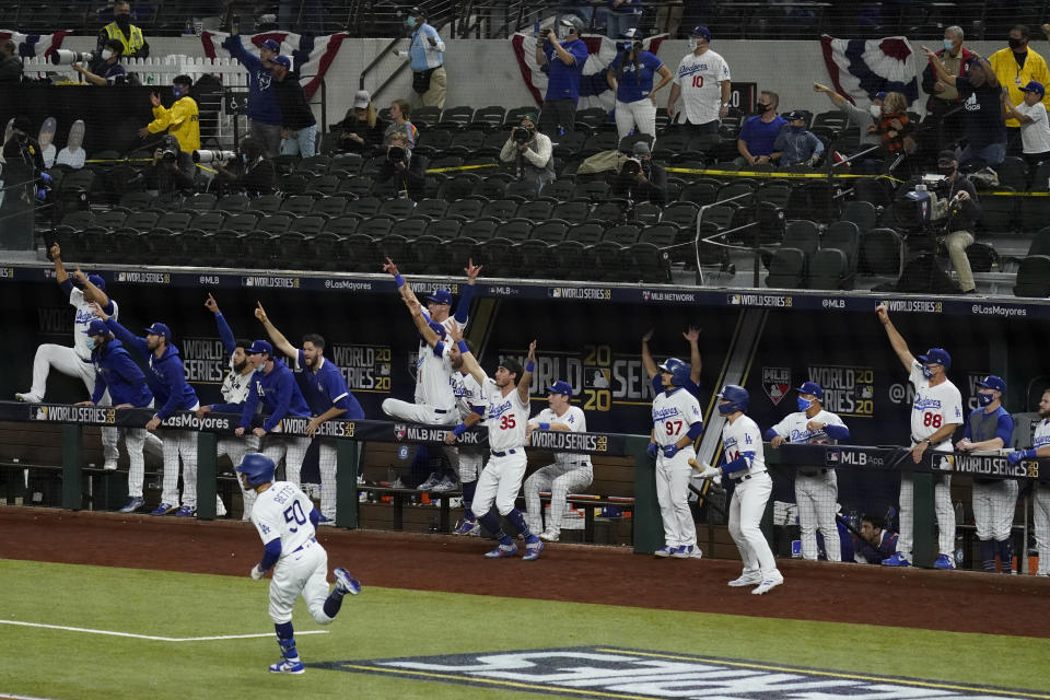 Los Angeles Dodgers' Mookie Betts celebrates after a home run against the Tampa Bay Rays during the eighth inning in Game 6 of the baseball World Series Tuesday, Oct. 27, 2020, in Arlington, Texas. (AP Photo/Tony Gutierrez)