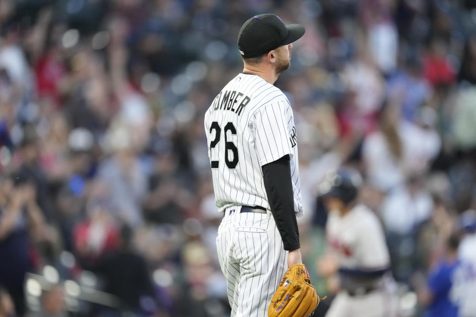 Colorado Rockies starting pitcher Austin Gomber reacts after giving up a grand slam to Atlanta Braves' Travis d'Arnaud in the fifth inning of a baseball game Thursday, June 2, 2022, in Denver. (AP Photo/David Zalubowski)