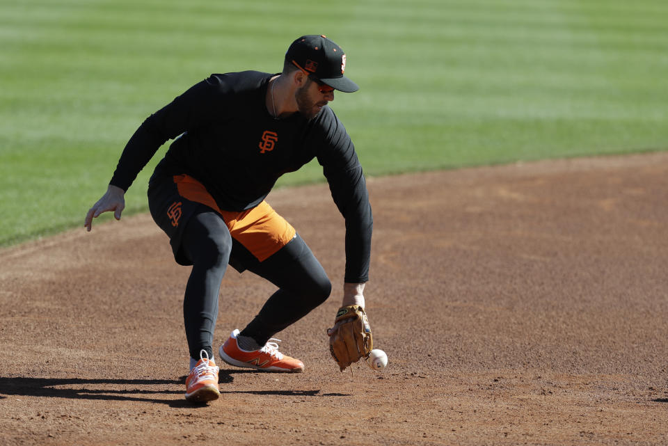 San Francisco Giants' Evan Longoria fields a ground ball during spring training baseball practice, Friday, Feb. 14, 2020, in Scottsdale, Ariz. (AP Photo/Darron Cummings)