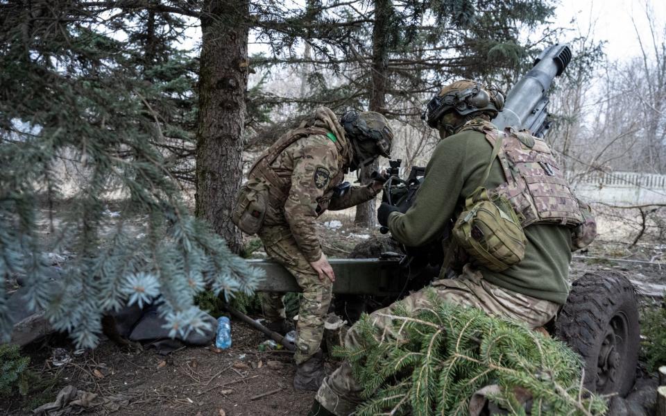 Ukrainian soldiers of the 1st Presidential Brigade of the Ukraine National Guard fire artillery shells with a decades-old 105mm Italian pack howitzer at Russian positions on February 16, 2024