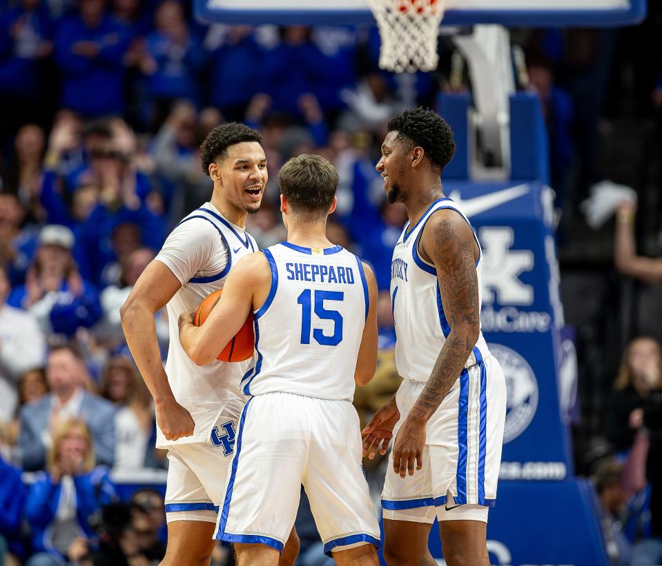 Kentucky's Tre Mitchell, Reed Sheppard and Justin Edwards celebrated at the end of overtime Monday night.