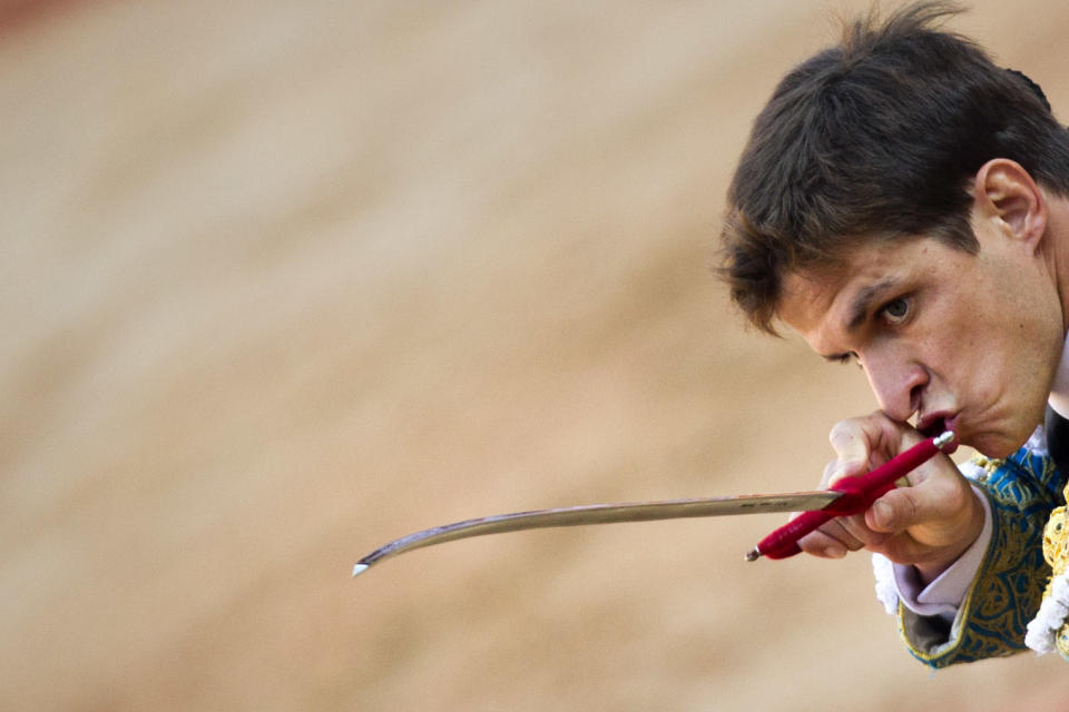 File - In this July 14, 2011 file photo, Spanish bullfighter Julian Lopez 'El Juli' aims his sword to kill a bull during a bullfight in Pamplona, Spain. Bullfights return live to Spanish state TV Wednesday Sept. 5, 2012, six years after the fights were banned from the widely watched public channel with the broadcast featuring one of Spain's most storied bullfighters and giving a boost to a tradition hit hard by declining popularity and a dire economic crisis. Julian Lopez, known by his nickname “El Juli,” will kill hulking half-ton bulls raised by a renowned breeder. He and other fighters are waiving payments demanded in better economic times for the right to broadcast their battles, a decision that helped Spain's new austerity-minded conservative government in its drive to get the fights back on national TV and promote bullfighting as important cultural heritage. (AP Photo/Daniel Ochoa de Olza, File)
