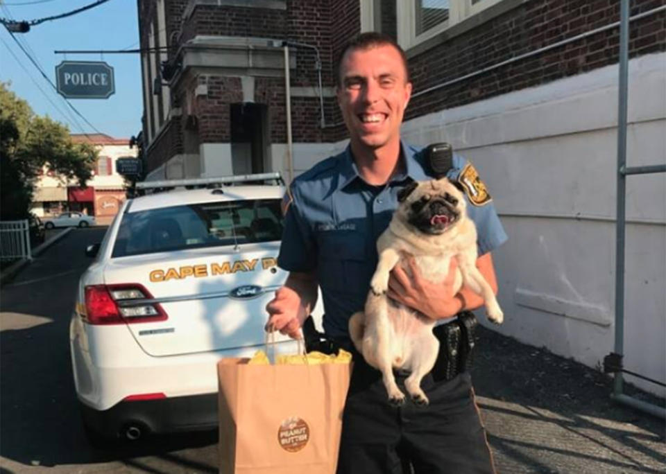 Apparently the pug paid her bail in cookies. The released inmate is pictured with <span>Patrolman Michael LeSage</span>. Source: Cape May Police Department