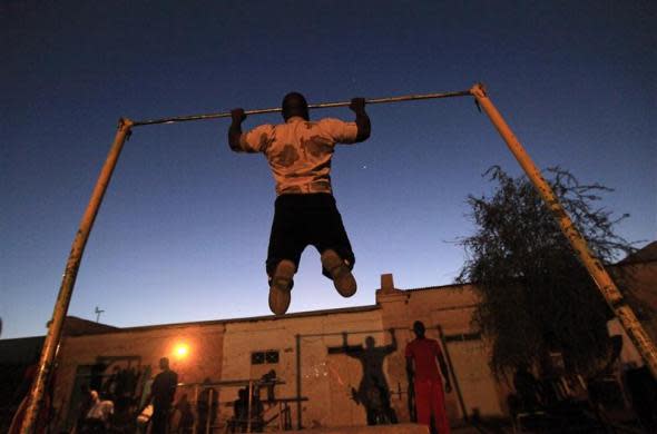 A member of the national weightlifting team trains as he prepares to compete with other athletes for the selection of the Olympics team in Khartoum, Sudan, February 28, 2012.