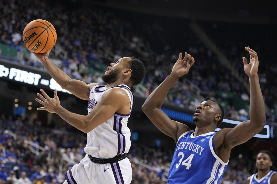 Kansas State guard Markquis Nowell shoots over Kentucky forward Oscar Tshiebwe during the first half of a second-round college basketball game in the NCAA Tournament on Sunday, March 19, 2023, in Greensboro, N.C. (AP Photo/Chris Carlson)