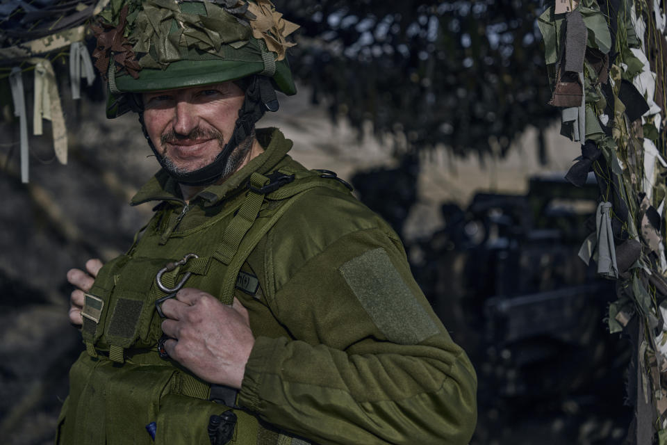 A Ukrainian soldier looks from their position on the frontline in Bakhmut, Donetsk region, Ukraine, Wednesday, March 22, 2023. (AP Photo/Libkos)