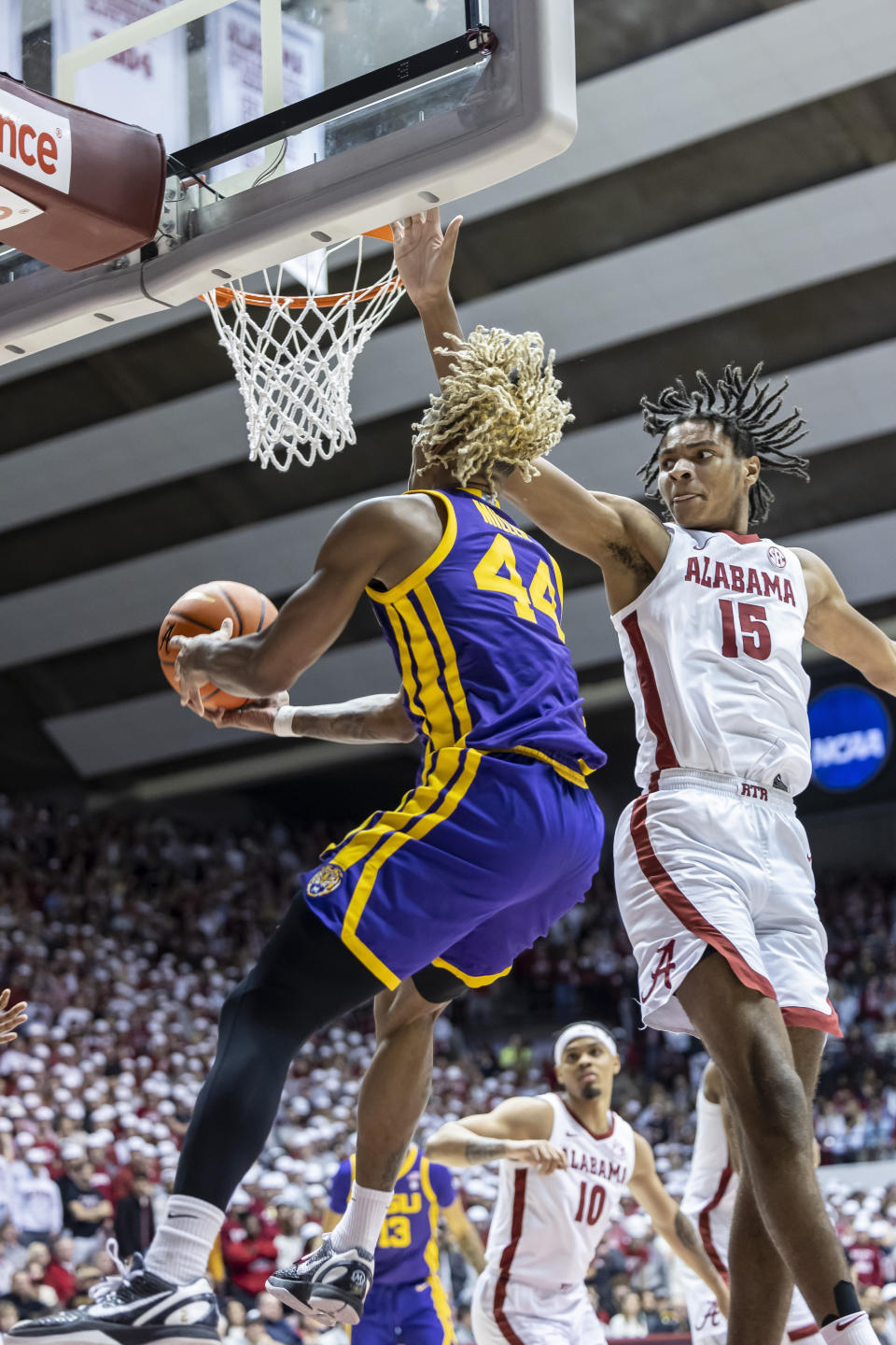 Alabama forward Noah Clowney (15) defends as LSU guard Adam Miller (44) gets inside to shoot during the first half of an NCAA college basketball game, Saturday, Jan. 14, 2023, in Tuscaloosa, Ala. (AP Photo/Vasha Hunt)