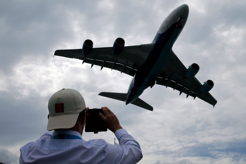 FILE PHOTO: A visitor takes a picture of an Airbus A380 as it lands after an air display at the 53rd International Paris Air Show at Le Bourget Airport near Paris