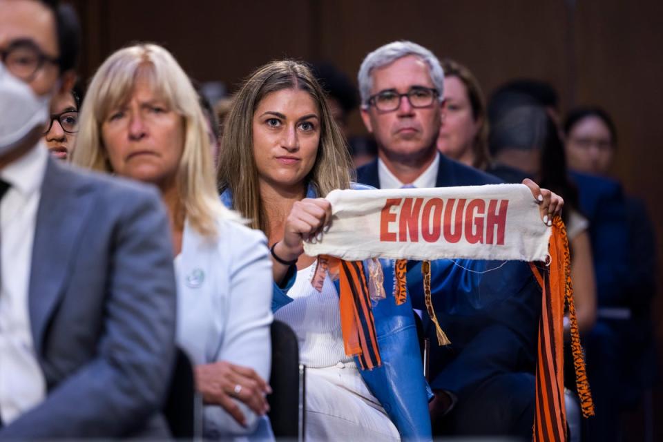 Allie Rubin of Highland Park, Illinois holds a ribbon during a Senate Judiciary Committee hearing on assault weapons on 20 July. (EPA)