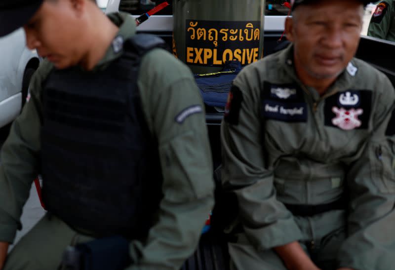 Soldiers pass their time in front of the Terminal 21 shopping mall following a gun battle involving a Thai soldier on a shooting rampage, in Nakhon Ratchasima