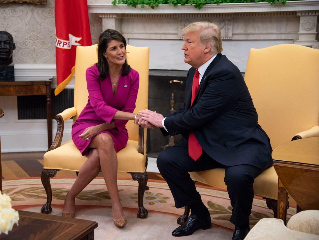 Nikki Haley, United States Ambassador to the United Nations, shakes hands with President Donald Trump after she announced her plan to resign at the end of the year in the Oval Office of the White House on October 9, 2018, in Washington, DC.