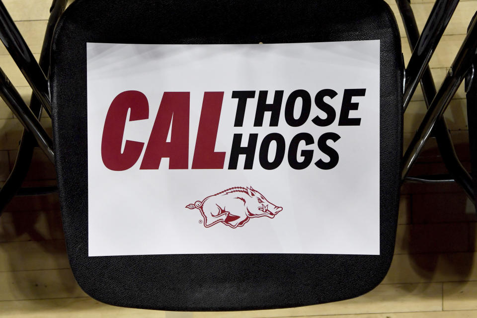 A sign sits on a chair in the audience are before the introduction of John Calipari as Arkansas men's basketball coach Wednesday, April 10, 2024, in Fayetteville, Ark. (AP Photo/Michael Woods)