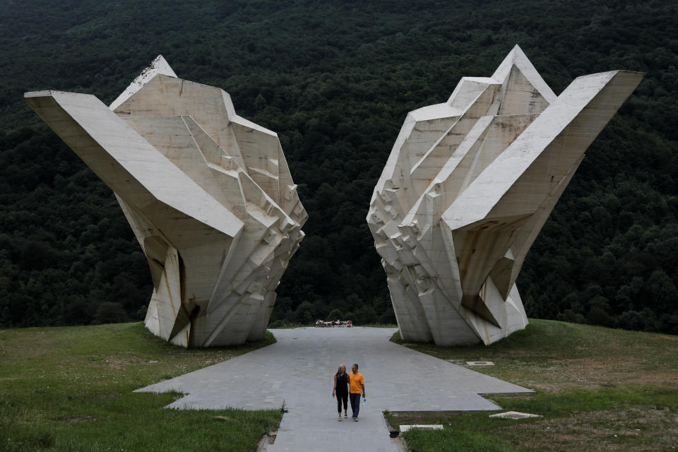 A couple walk in front of the war memorial monument "Battle of Sutjeska" in Tjentiste, Bosnia and Herzegovina. Examples of Yugoslav brutalism include the huge memorials commemorating the struggle against fascism, often placed in dramatic rural settings. Many of those pieces of art remain in disrepair; however, the Tjentiste memorial, commemorating the killing of 7,000 people by the Nazis was renovated last year. (Photo: Marko Djurica/Reuters)