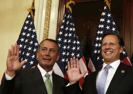 U.S. Speaker of the House John Boehner (R-OH) (L) and Rep. David Brat (R-VA) (R), one of the new members of the 113th Congress, are seen during a ceremonial swearing event in Washington November 12, 2014. REUTERS/Gary Cameron