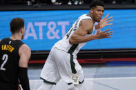 Milwaukee Bucks forward Giannis Antetokounmpo (34) reacts after dunking, next to Brooklyn Nets forward Blake Griffin (2) during the first half of Game 5 of a second-round NBA basketball playoff series Tuesday, June 15, 2021, in New York. (AP Photo/Kathy Willens)